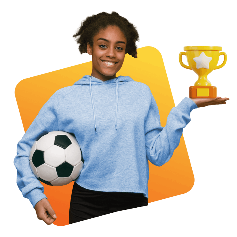 A girl proudly holds a soccer ball in one hand and a trophy in the other, celebrating her achievement in sports.