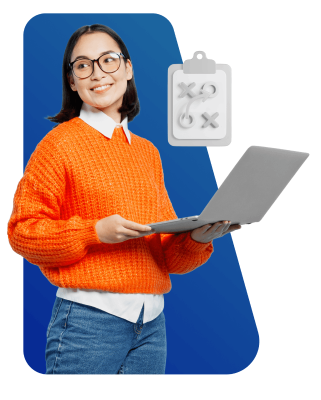 A woman wearing an orange sweater is holding a laptop, focused and engaged in her work.