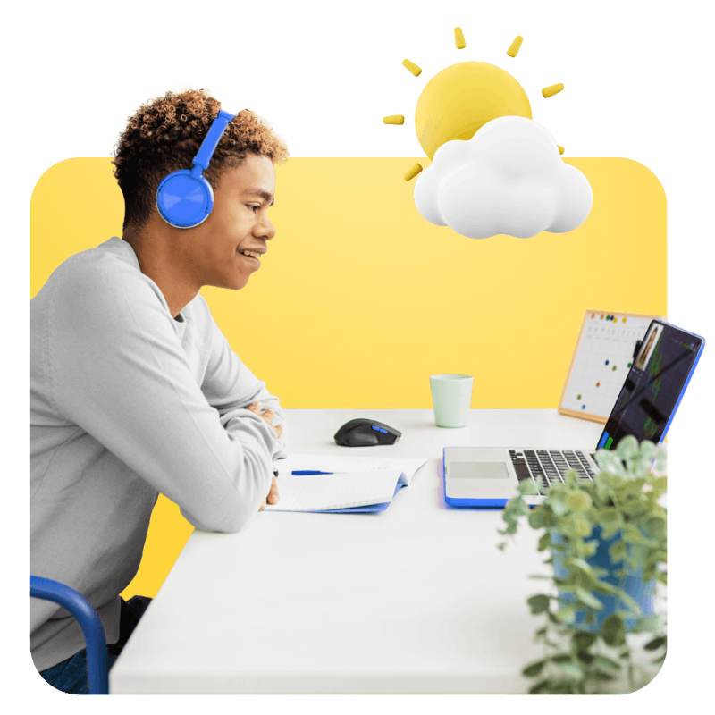 A man focused on his laptop, wearing headphones, immersed in his work environment.