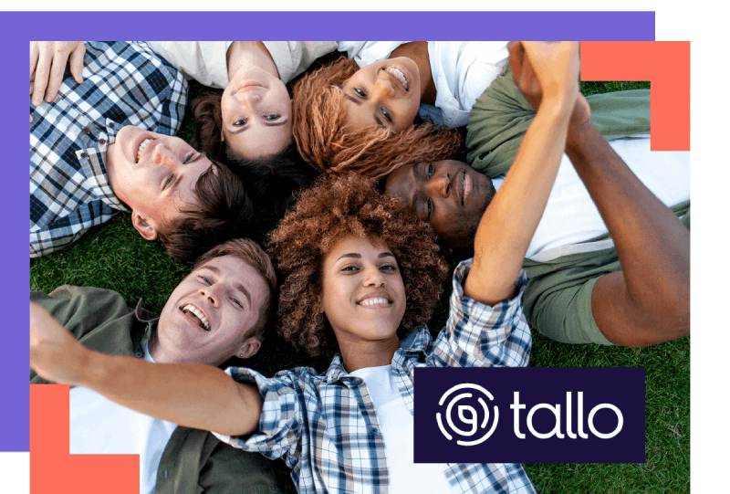 A diverse group of six people lies on grass in a cheerful circle, heads together, smiling and taking a selfie. "Tallo" logo is at the bottom.